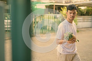 Young Asian man bringing pineapple at home