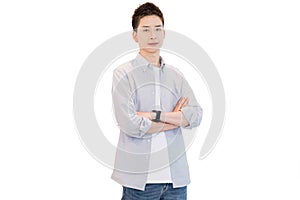 Young Asian man in casual gray shirt.He is standing with arms folded feeling confidence to work. Smart working concept