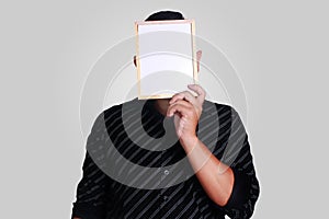 Young Asian Man Covering His Face With Small Whiteboard