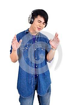 Young asian man dance, swaying, and lifting his arms rhythmically while listening to the music from headphone. Portrait on white