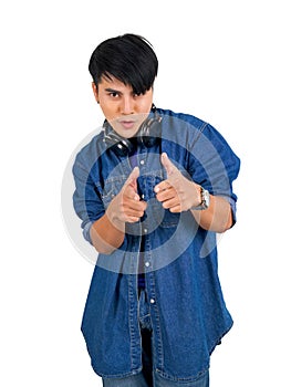 Young asian man dress in jean with headphone pointing finger in front direction. Portrait on white background with studio light.