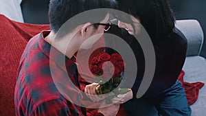 Young asian man giving red roses to his girlfriend. Happy valentines day