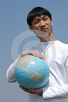 Young Asian Man with a Globe
