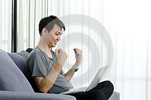 Young asian man hands happiness moment with computer laptop.