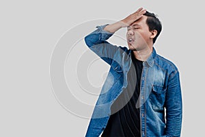 Young Asian Man with head palm gestures in disbelief expressions