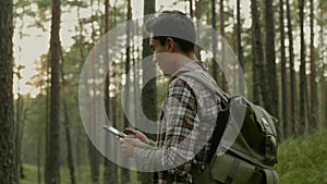 Young asian man hiking in a forest