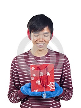 Young Asian man holding gift bag