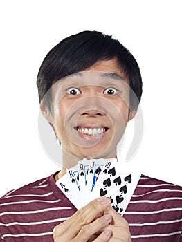 Young Asian man holding playing cards