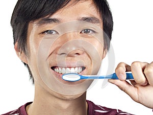 Young Asian man holding toothbrush