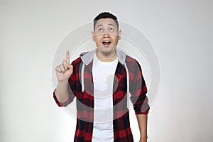 Young Asian man looked happy thinking and looking up, having good idea. Half body portrait against white