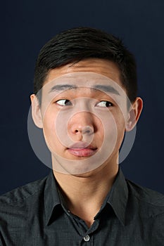 Young Asian man looking sideways