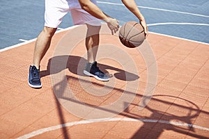 Young asian man playing basketball