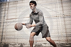 Young asian man playing basketball