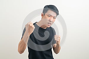 Young Asian man with punching hand