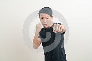 Young Asian man with punching hand