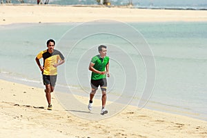 Young Asian man running on beach, Sport concept