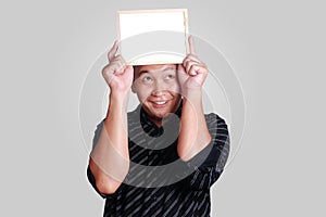 Young Asian Man Showing Small Whiteboard Covering His Head