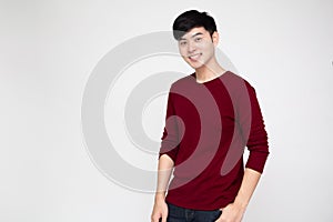 Young Asian man smiling and looking at camera isolated on white background