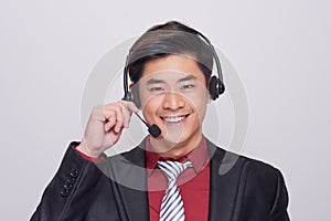 Young asian man in suit wearing a headset