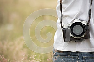 Young asian man taking photo outdoors with DSLR digital camera. Young cheerful female tourist having fun in coffee shop.