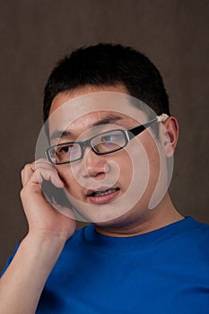 Young asian man talking on the phone