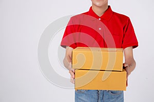 Young asian man in uniform red and cap standing carrying box stack isolated white background.