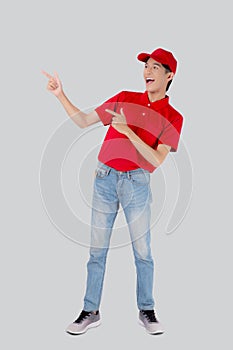 Young asian man in uniform red and cap standing presenting with excited isolated on white background.