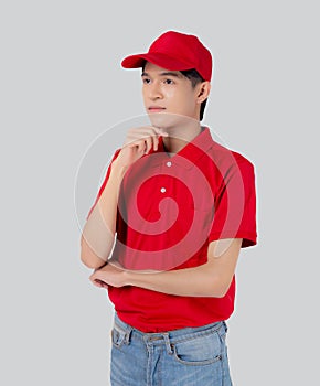 Young asian man in uniform red and cap standing and thinking idea isolated on white background.
