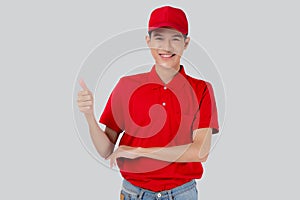 Young asian man in uniform red and cap standing thumbs up with confident isolated on white background.