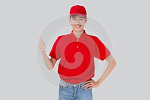 Young asian man in uniform red and cap standing thumbs up with confident isolated on white background.