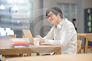 Young Asian man university student doing homework