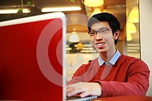 Young asian man using laptop