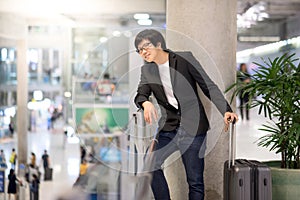 Young asian man waiting in airport terminal