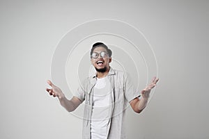 A young Asian man wearing glasses on an  white