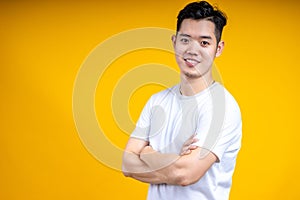 Young Asian man wearing posting isolate on yellow background