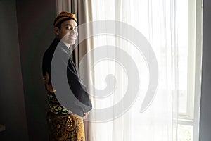 Young asian man wearing traditional clothes of indonesian beskap