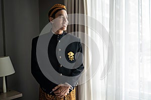 Young asian man wearing traditional clothes of indonesian beskap