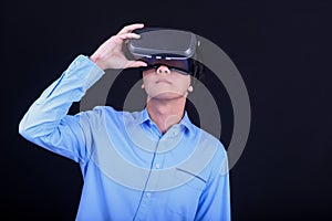 Young Asian man wearing virtual reality goggles