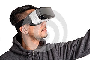 Young asian man wearing virtual reality goggles looking upwards