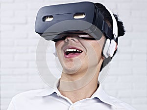 Young asian man wearing VR goggles
