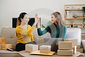 young Asian man and woman at office of their business online shopping marketing, packaging, concept..In home office