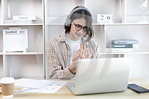 Young Asian men are greeting friends and teachers through video chats and greeting them with cheerful expressions