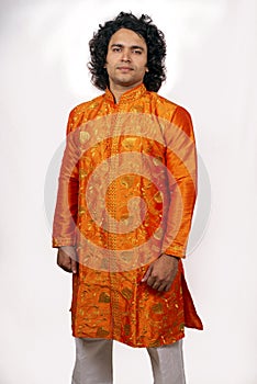 Young asian model wearing orange kurta