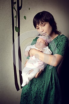 Young Asian mother holding newborn baby girl