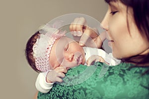 Young Asian mother holding the shoulder of the baby