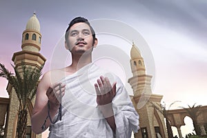 Young asian muslim man wearing ihram clothes