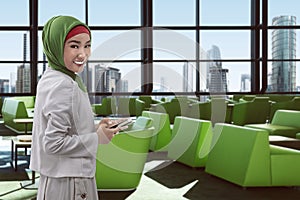 Young asian muslim woman on the airport
