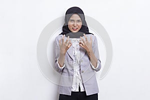 Young asian muslim woman angry emotional shouting and screaming on white background