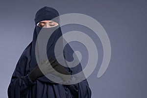 Young asian muslim woman wearing niqab with peaceful expression