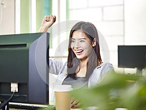 Young asian office lady excited at good news